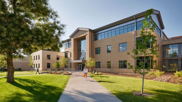 The CSU Nutrien Agricultural Sciences Building, a modern three-story brick facility with large windows and landscaped walkways, located on the Colorado State University campus.