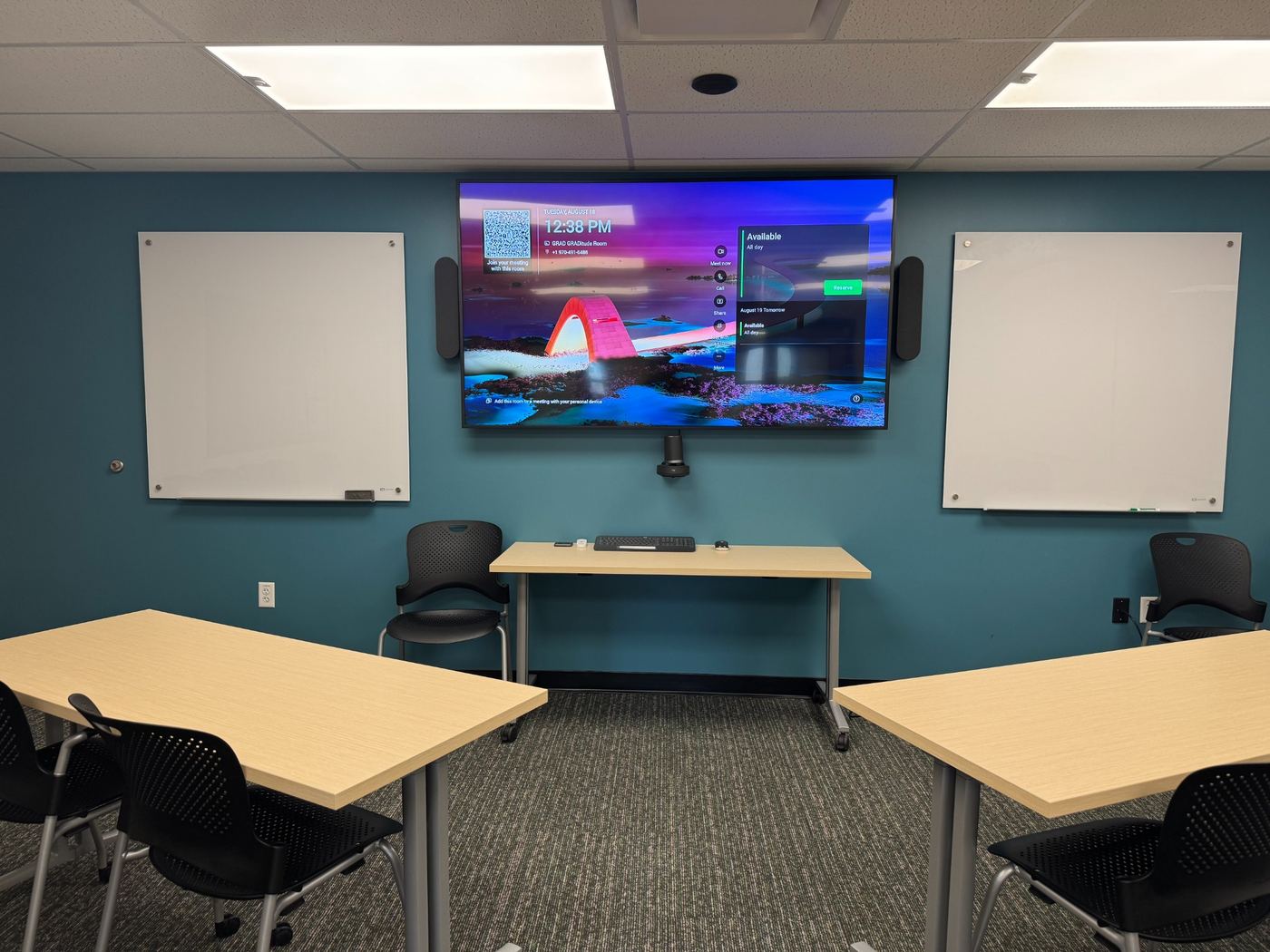 Flex space with audio and visual upgrades including a large LED monitor, sound bar, and conferencing system.